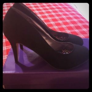 Women’s black suede heels.